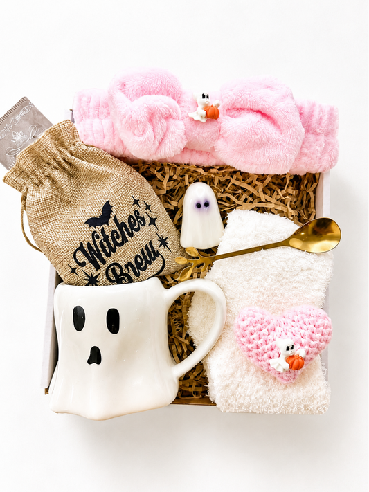 Pink Halloween gift basket for women with ghost mug, Witch's Brew tea, fuzzy socks, shower headband, ghost soap, crochet heart plush and gold spoon