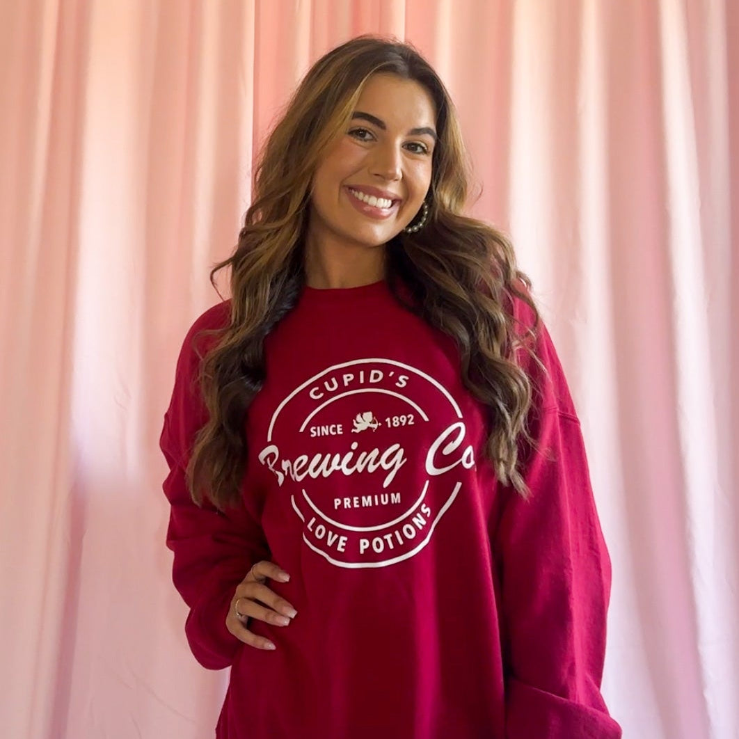 Valentines Day Sweatshirt Women Oversized Red Pullover Cozy Soft Fabric Cupids Brewing Co Design Love Potions Logo Relaxed Fit Comfortable Wear Perfect Valentine Gift Holiday Outfit Casual Style Winter Comfort Wear Bold Red Color Premium