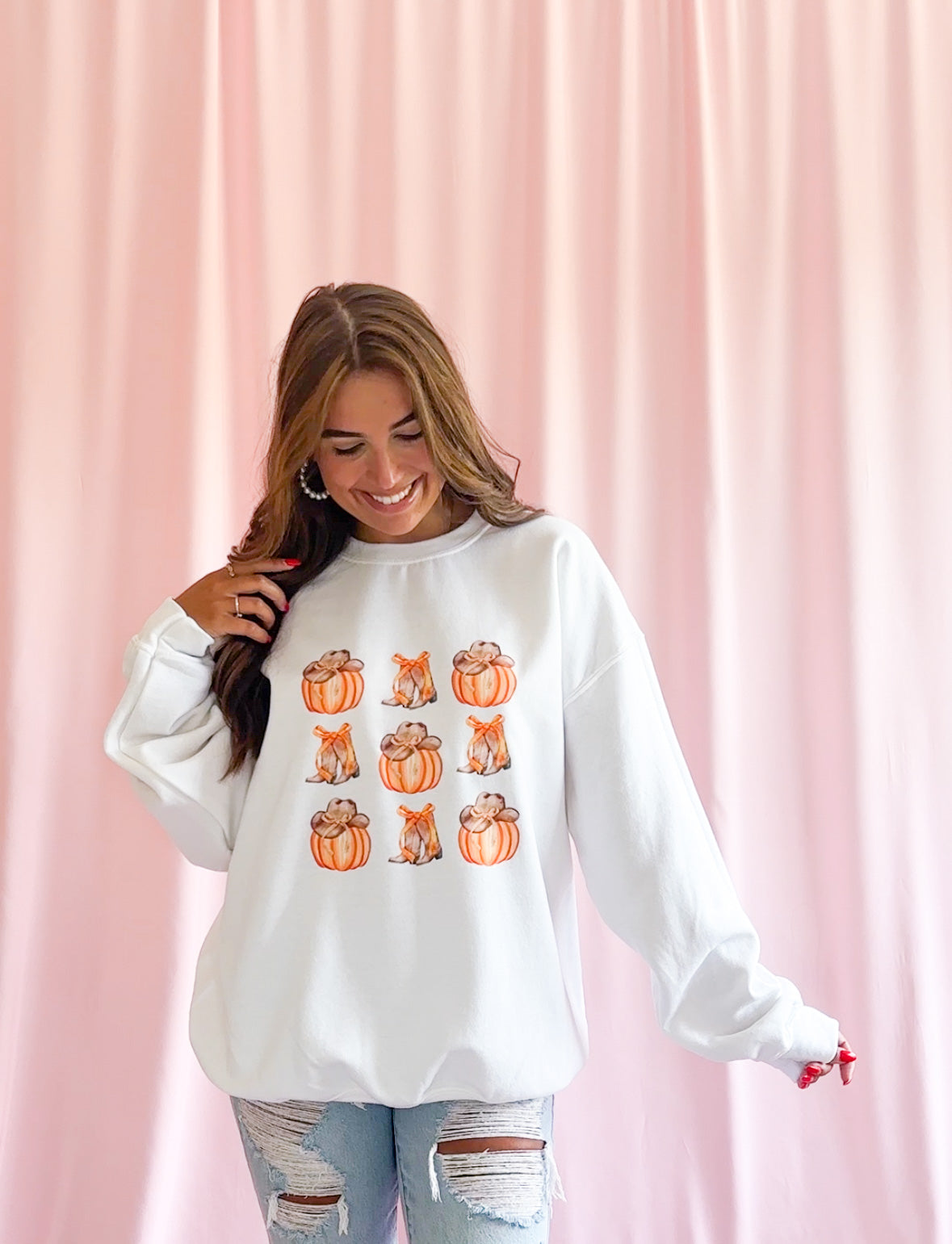 Fall Western Sweatshirt Pumpkin Cowboy Design Autumn Fashion Statement Comfortable Seasonal Clothing Warm Cozy Fabric Cowgirl Boot Pattern Orange Bow Detail Perfect Casual Fall Outfit Essential Western Theme Celebration Wear Cute Pumpkin