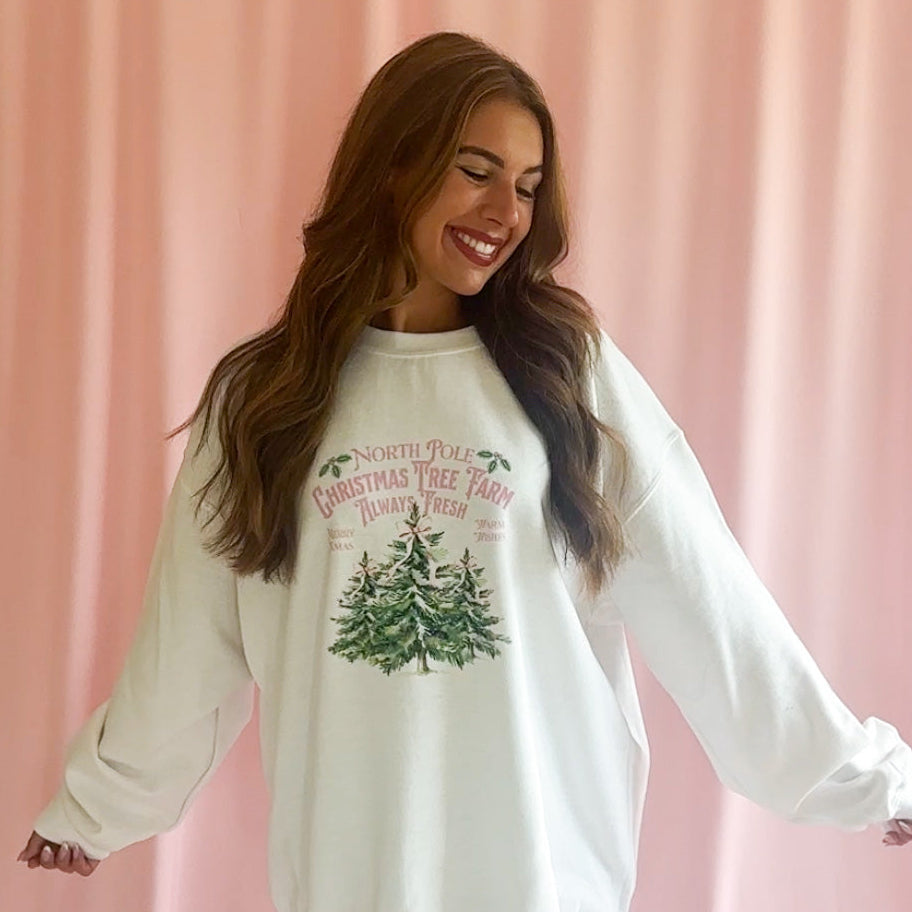 Cozy Holiday Fashion Pink Christmas Sweatshirt Girly Coquette Bow Design Festive Winter Comfort Wear Christmas Party Outfit Essential Feminine Style Statement Seasonal Fashion Collection Elegant Pink Holiday Attire Comfortable Winter